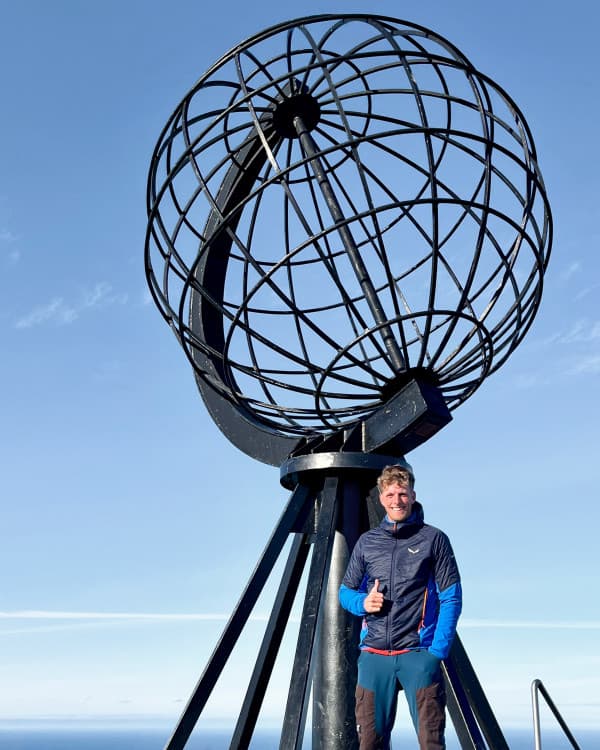 The iconic globe monument at the North Cape - @van4life__ 10/2024 Chris (@van4life__) standing in front of the iconic globe monument at the North Cape, the northernmost point in Europe. Smiling and giving a thumbs up, Chris marks a key moment of his Arctic Circle adventure under clear blue skies. This photo highlights the significance of reaching this landmark during his vanlife journey.