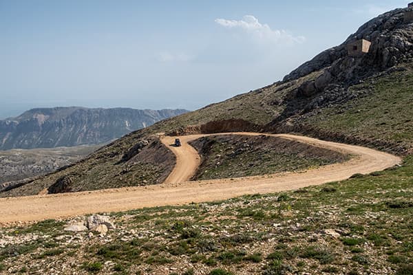 Off-road driving, Türkiye - @char.is.far 01/2025 @char.is.far's Toyota 4Runner navigating a winding dirt road on a mountainous off-road trail in Türkiye. The rugged terrain is surrounded by scenic views of rolling hills and distant rocky peaks, highlighting the adventurous spirit of overlanding through remote regions. This image captures the essence of off-road exploration as part of their journey from Europe to Asia.