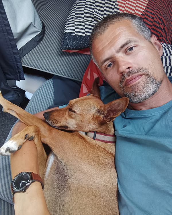My faithful companion Boswell - @minimalistlandscapes 12/2024 Daniel (@minimalistlandscapes) resting with his loyal companion Boswell, a small brown dog, cuddled up inside their camper van, showcasing the bond and comfort of vanlife living.