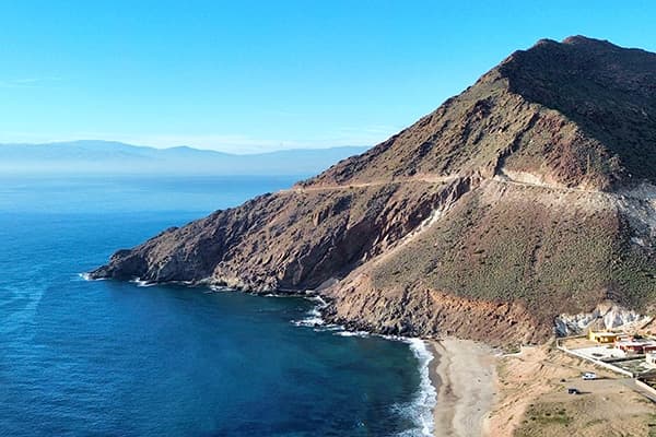 Coastal cliffs of Cabo de Gata in southeastern Spain - @van4life__ 05/2025 Drone view of a remote beach and rugged coastline near Cabo de Gata-Níjar Natural Park in southern Spain, showcasing dramatic cliffs and the calm Mediterranean Sea.